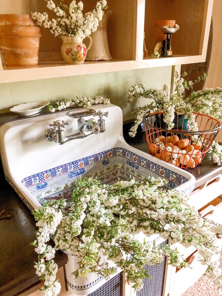 Large farmhouse sink filled with white flower