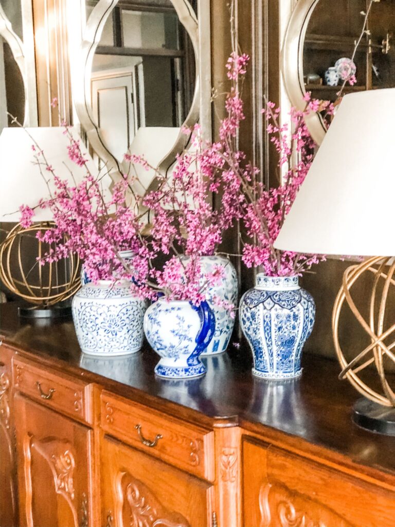 Blue and white vases filled with redbud stems