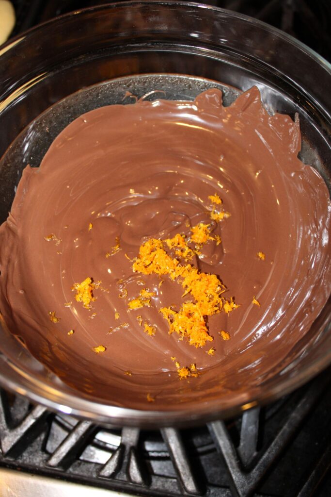 Melted chocolate and orange zest ready for dipping
