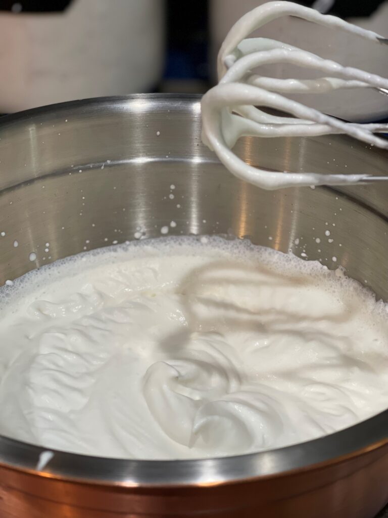 Beat the whipping cream until soft peaks form.
