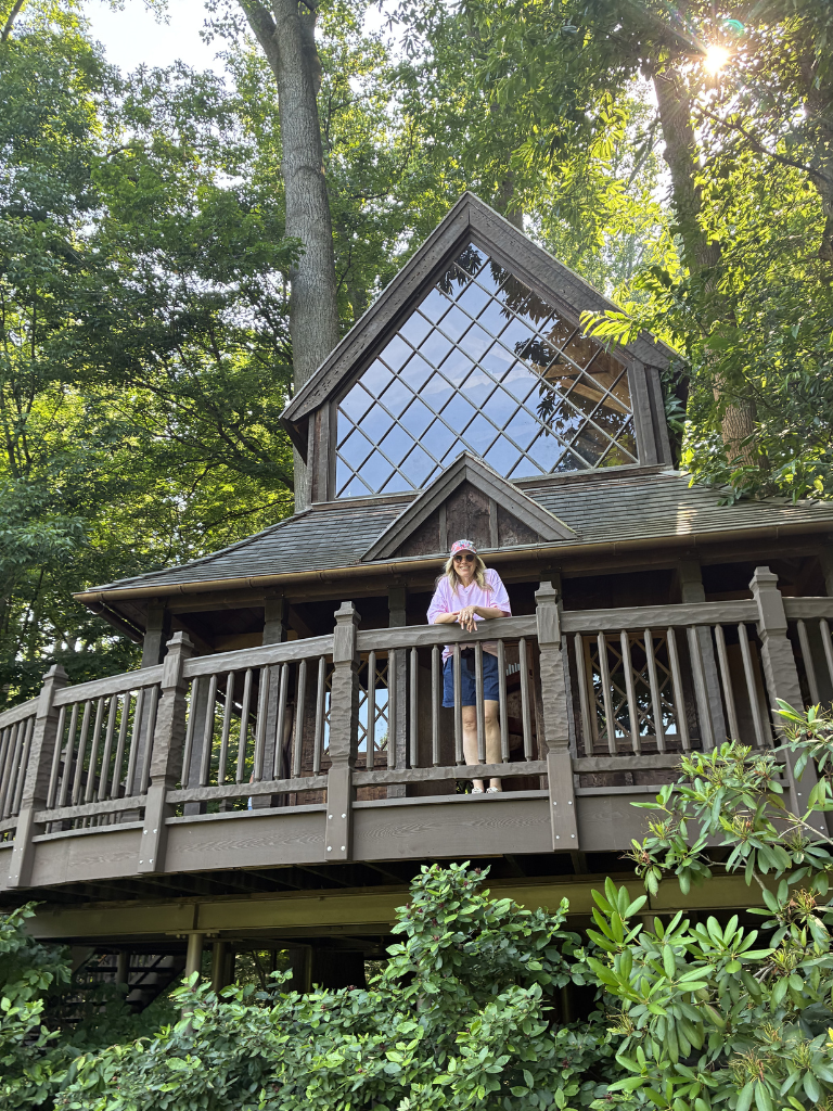 A retired woman in a treehouse at longwood gardens celebrating retirement